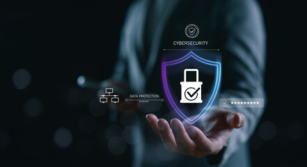 Businessman holding a digital shield with lock icon, representing cybersecurity, data protection,...