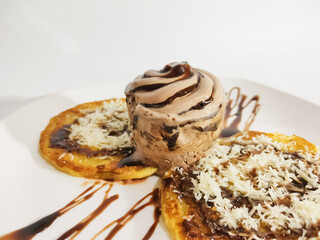 Roti Maryam With Chocolate, Ice Cream and Cheese in White Plate on White Background.