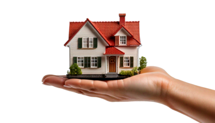A realistic image of a human hand holding a small, detailed model house with red roof tiles, green window shutters, and surrounding miniature landscaping, set against a transparent background Png