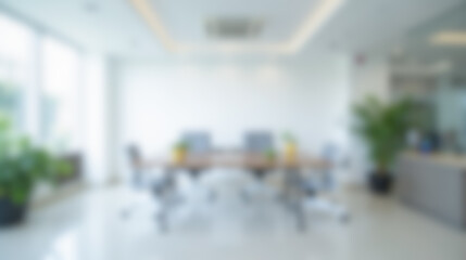 Blurred office scene featuring clean and stylish workspace, large windows, natural light, wooden...