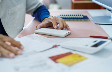 asian man use mobile phone to pay expenses from receipt and many bill of various expenses after spending via credit card, concept of home shopping, online shopping