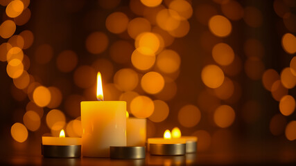 Burning candles on floor in darkness.