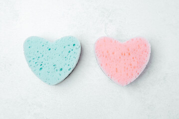 Fototapeta premium Colorful heart-shaped sponges in pastel tones for cleaning tasks
