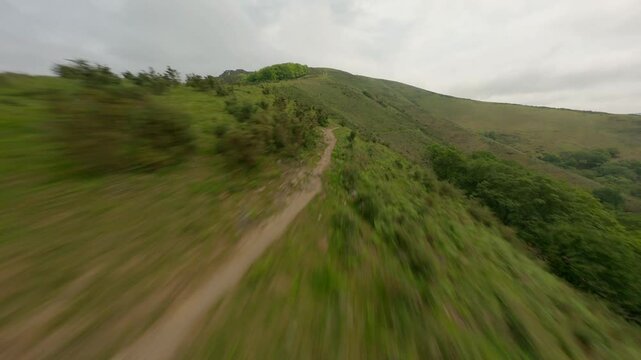 Racing drone flying over hills, Ainhoa, France. Aerial FPV