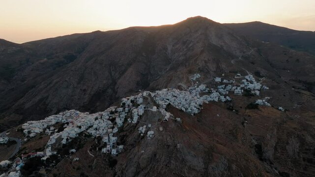 Panoramic drone shot of Serifos island Chora, Cyclades islands, Aegean sea at sunset