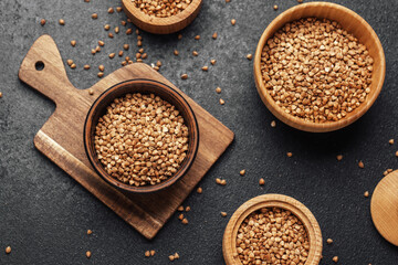 Buckwheat grains arranged artistically on wooden bowls and board in a kitchen