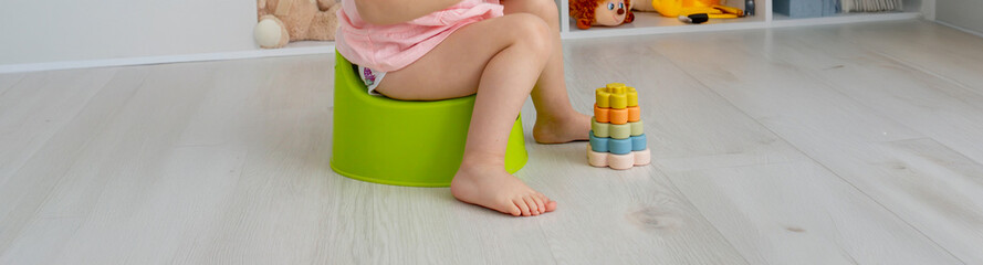 Child sitting on potty. Toddler potty trained