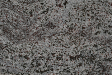Rough gray granite texture with black speckles.