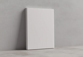 There is an open book that has white pages resting on a gray surface