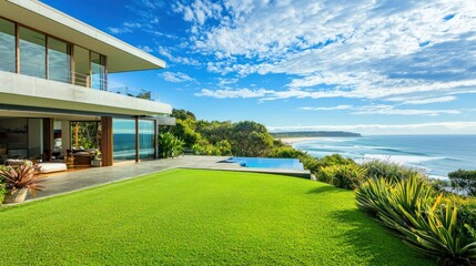 A real estate listing of a beautiful coastal property, featuring expansive lawns and a modern home with ocean vistas.