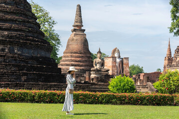 Traveler and woman tourist enjoy walking to see the historic park of Thailand exciting to explore...