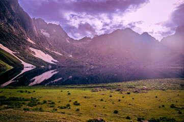 Mountain landscape with a lake.  Panoramic view from Sonmarg, Kashmir valley in the Himalayan region. Serene meadows, alpine trees, wildflowers on the trails of the Great Lakes of Kashmir, 2021.

