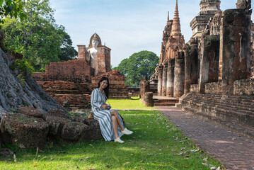 Traveler and woman tourist enjoy walking to see the historic park of Thailand exciting to explore...