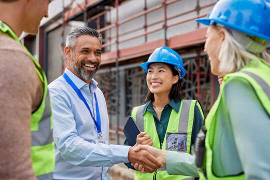Construction worker shaking hands with foreman