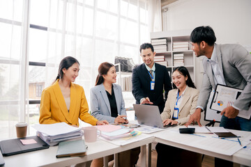 Brainstorming of young modern group. Team meeting to achieve goal. Business people discussing finance business and analysis. Teamwork concept in modern office. Calculating personal tax for client.