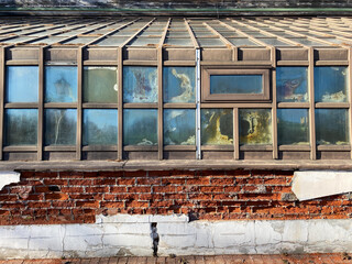 Abandoned, dilapidated building of former greenhouse or winter garden for thermophilic plants