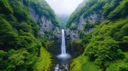 Waterfall Lush Green Valley Dramatic Nature High Resolution Aerial View Stunning Cliffs Cascading Water Mountainous Landscape Emerald Green Tones Travel Advertisement