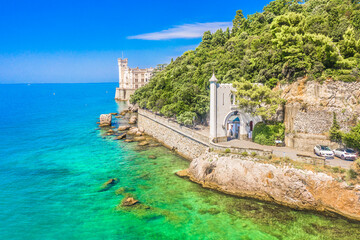 A stunning aerial view of famous landmark near Trieste, Italy, perched on a rocky promontory above the Adriatic Sea, surrounded by turquoise waters, showcasing elegance and coastal charm