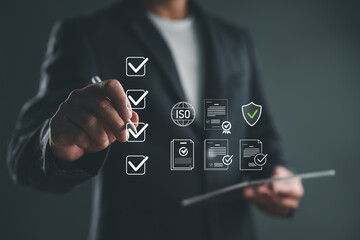 Businessman ticking checklist items and document icons, representing ISO certification, quality control, compliance audit, data verification, document approval, and business standards.