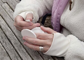 A woman holds one bag of snus in her hand.A box of snus pads replaces smokeless cigarettes. Swedish...