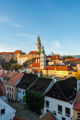 Obraz premium Panoramic view of Cesky Krumlov, featuring the historic castle tower and the church of St. John of Nepomuk. The medieval town's charm is beautifully captured on a sunny day