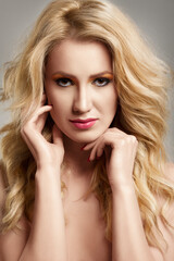 Naklejka premium Portrait of beautiful woman with blonde curly hair