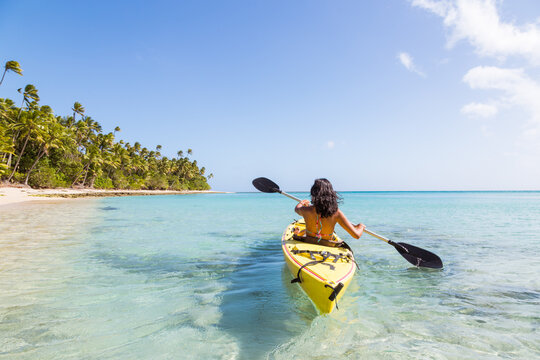 Woman on kayak near beach in a tropical island, Fiji