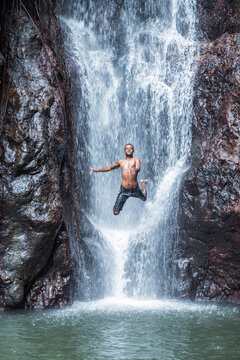 Man jumping off a waterfall, Kadavu, Fiji