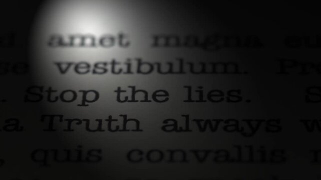 Truth always wins. Stop the lies. Moving text printed on a page. Slow motion. A piece of paper with a phrase written in retro typewriter font. Spotlight effect. Dark dramatic video.