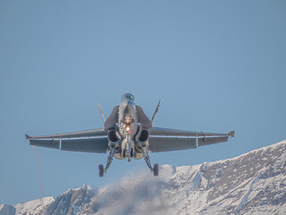 An F/A-18 of the Swiss Air Force approaches for landing and taxis on the runway at the airbase. The...