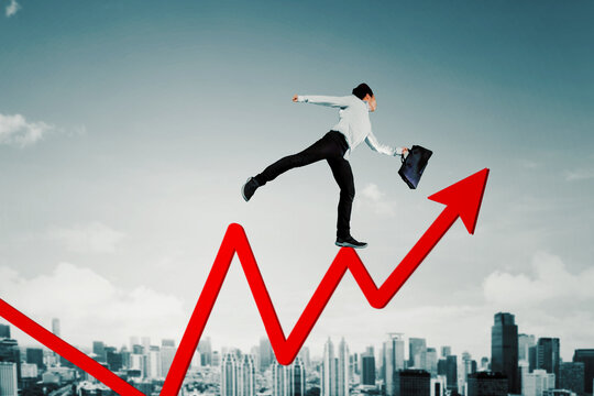 Businessman Jumping on Upward Graph Arrow – Economic Growth and Success Concept