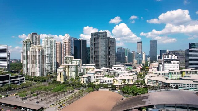 Taguig, Metro Manila: Apr 17, 2025 &mdash; Aerial flyby of Bonifacio Global City skyline showing dense modern towers and urban layout.