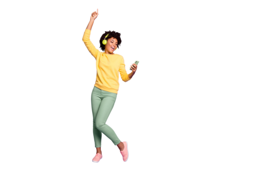 Full length body size photo of curly wavy trendy sweet cute carefree girl dancing and singing while reading song text on her telephone and wearing headphones isolated violet pastel color background