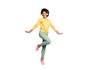 Full length body size turned photo of cheerful positive cute nice charming girlfriend dancing in headphones wearing yellow sweater green pants trousers isolated over violet pastel color background