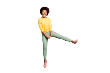 Full size photo of cheerful funny funky teen afro american girl jump have fun on autumn weekends spring free time wear yellow pullover green pants trousers isolated over purple violet color background