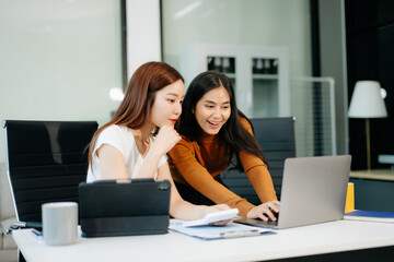 Business portrait two woman asian  smile cheerful talk and holding tablet, computer and hands up happy with in agreement ready new project
