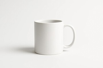 Obraz premium A plain white ceramic mug centered on a seamless white background