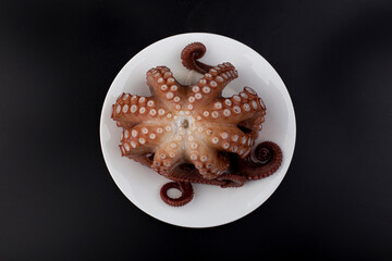 boiled octopus on a plate. © bong