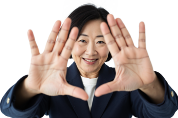 Smiling East Asian businesswoman making a framing gesture with her hands, focusing attention, creative concept portrait isolated against a transparent background for versatile use