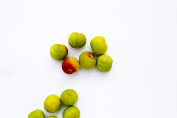Fresh green plum on white background
