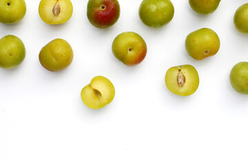 Fresh green plum fruit on white background.