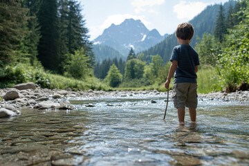 Child exploring a mountain river in the alps