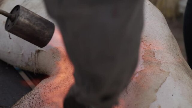 Torch flame burning pig skin to remove hair in traditional northern Portuguese butchering