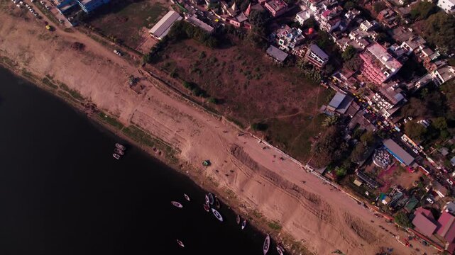 bird eye view of ganga river with buildings and Kurukshetra Pokhra at day time, tilt up, drone shot, 4k.