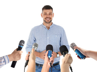 Journalists with microphones interviewing man on white background, closeup