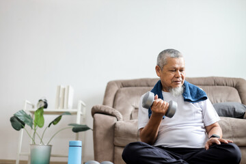 Senior Asian man doing strength training with dumbbells
