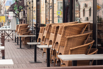 A stack of chairs on the summer terrace of a street cafe in the early morning.