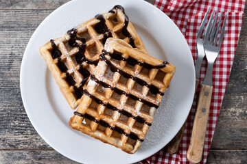 Belgian Waffles with chocolate on on wooden table. Top view