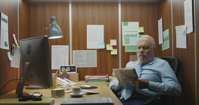 Inefficient employee doing a crossword puzzle instead of working