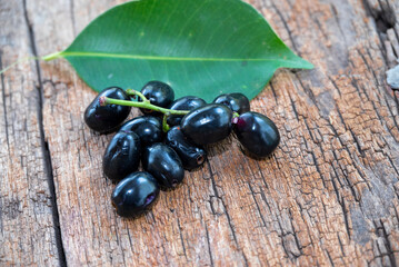 Jambolan plum, Java plum, Jambul( Syzygium cumini (L.) Skeels. on wooden background